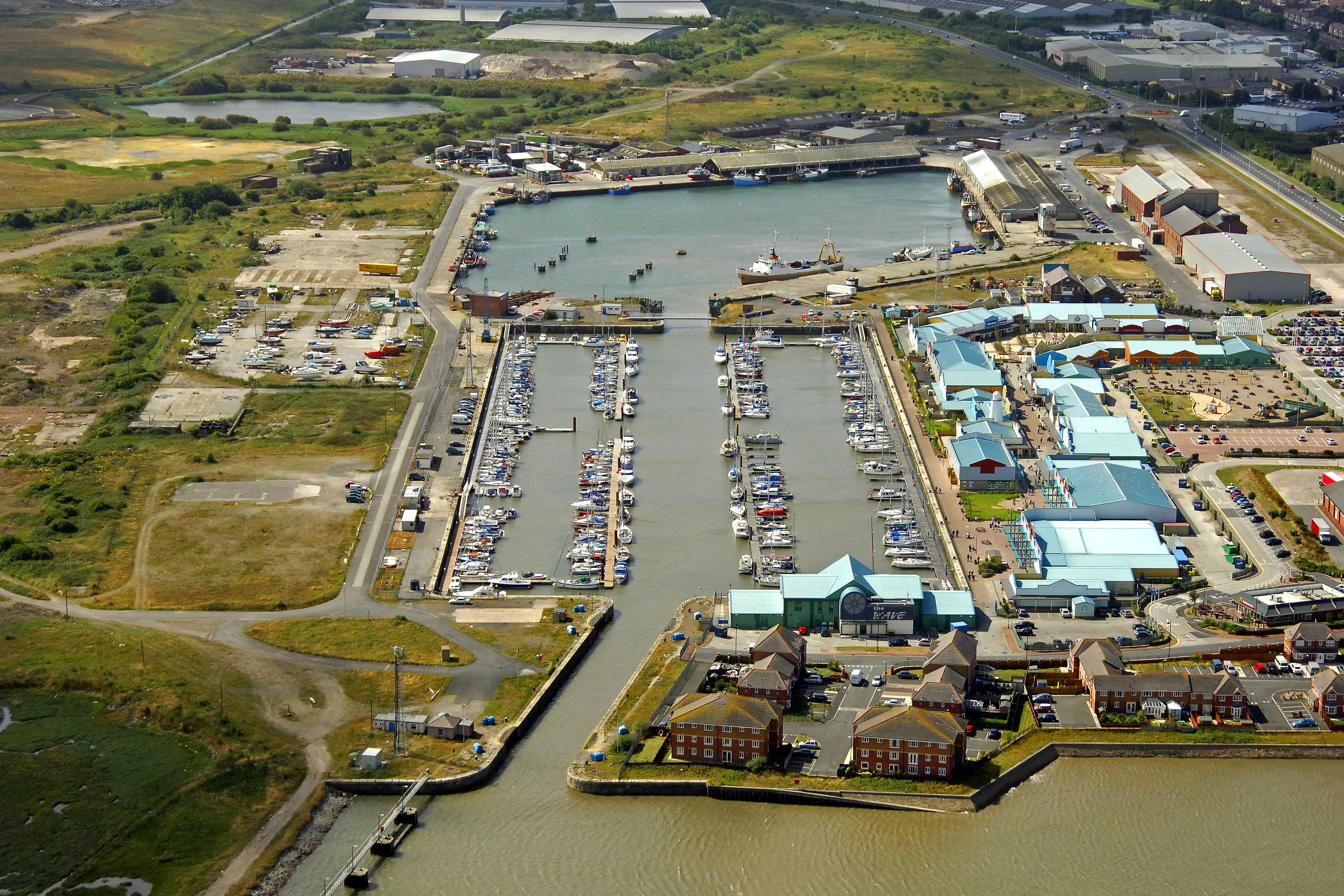 Aerial view of Wyre Dock at the Port of Fleetwood, with the marina pontoons behind the lock and the commercial dock beyond